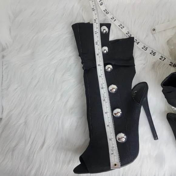 Black boots stiletto heel open toe silver studs.